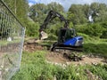 With an excavator of the technical relief organization the rubble of a building site is loaded