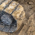 Excavator track pad and tread mark on dirt
