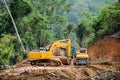excavator and truck in the road construction job, countryside of Myanmar Royalty Free Stock Photo