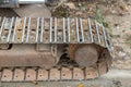 Excavator tracks. Old iron caterpillars of the bulldozer of the tractor on the road. bulldozer caterpillar tracks. Black caterpill Royalty Free Stock Photo