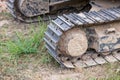 Excavator tracks. Old iron caterpillars of the bulldozer of the tractor on the road. bulldozer caterpillar tracks. Black caterpill Royalty Free Stock Photo