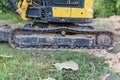 Excavator tracks. Old iron caterpillars of the bulldozer of the tractor on the road. bulldozer caterpillar tracks. Black caterpill Royalty Free Stock Photo