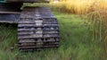 Excavator tracks. Old iron caterpillars of the bulldozer of the tractor on the road. bulldozer caterpillar tracks. Black caterpill Royalty Free Stock Photo