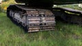 Excavator tracks. Old iron caterpillars of the bulldozer of the tractor on the road. bulldozer caterpillar tracks. Black caterpill Royalty Free Stock Photo