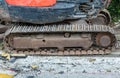 Excavator tracks. Old iron caterpillars of the bulldozer of the tractor on the road. bulldozer caterpillar tracks. Black caterpill Royalty Free Stock Photo