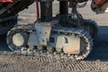 Excavator tracks. Old iron caterpillars of the bulldozer of the tractor on the road. bulldozer caterpillar tracks. Black caterpill Royalty Free Stock Photo