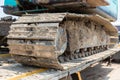 Excavator tracks. Old iron caterpillars of the bulldozer of the tractor on the road. bulldozer caterpillar tracks. Black caterpill Royalty Free Stock Photo