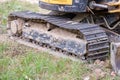 Excavator tracks. Old iron caterpillars of the bulldozer of the tractor on the road. bulldozer caterpillar tracks. Black caterpill