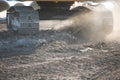 Excavator tracks putting up a dust cloud