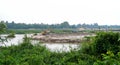 Excavator and truck move soil from reservoir