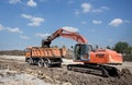 Excavator and truck working on road construction Royalty Free Stock Photo