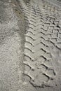 Excavator tyres footprint on quarry white sand Royalty Free Stock Photo