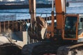 Excavator unloading sand into the dump truck on the construction site, excavating and working during road works, backhoe and Royalty Free Stock Photo