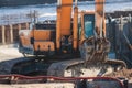 Excavator unloading sand into the dump truck on the construction site, excavating and working during road works, backhoe and Royalty Free Stock Photo