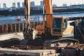 Excavator unloading sand into the dump truck on the construction site, excavating and working during road works, backhoe and Royalty Free Stock Photo