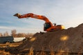 Excavator used for pipe laying works and house foundation. Doosan earth mover machine Russia, Omsk, 13.11.2019 Royalty Free Stock Photo