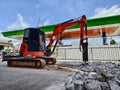 Excavator using hydraulic hammer for breaking concrete at a construction site Royalty Free Stock Photo