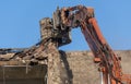 Excavator at work on demolition site Royalty Free Stock Photo