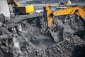 Excavator work loading of coal into Yellow mining truck. Open pit mine industry Royalty Free Stock Photo