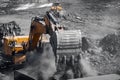 Excavator work loading of coal into Yellow mining truck. Open pit mine industry Royalty Free Stock Photo