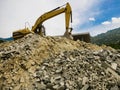 An excavator working on a construction and demolition waste plant