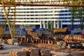 Excavator working at construction of a new metro line. Contractor digding the tunnel subway and railway station platform deep Royalty Free Stock Photo