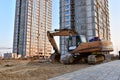 Excavator working at construction site. Backhoe on road work and earthworks. Earth-Moving Heavy Equipment for construction jobs, Royalty Free Stock Photo