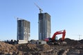 Excavator working at construction site. Backhoe on road work and earthworks. Earth-Moving Heavy Equipment for construction jobs, Royalty Free Stock Photo