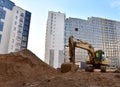 Excavator working at construction site. Backhoe on road work and earthworks. Earth-Moving Heavy Equipment for construction jobs, Royalty Free Stock Photo