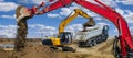 Excavator working on construction site with dramatic clouds on sky Royalty Free Stock Photo
