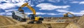 Excavator working on construction site with dramatic clouds on sky