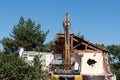 Excavator working demolition of house old residential building for reconstruction Royalty Free Stock Photo