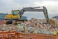 Excavator working at the demolition of an old industrial building. Royalty Free Stock Photo