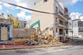 Excavator working at the demolition of an old residential building Royalty Free Stock Photo