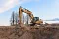 Excavator working on earthmoving at open pit mining. Backhoe digs gravel in quarry. Construction machinery for excavation, loading Royalty Free Stock Photo