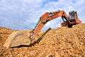 Excavator working on earthmoving at open pit mining. Backhoe digs gravel in quarry. Construction machinery for excavation, loading Royalty Free Stock Photo