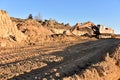 Excavator working on earthmoving at open pit mining. Backhoe digs sand and gravel in quarry. Heavy Construction Equipment Machines Royalty Free Stock Photo