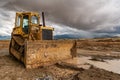 Excavator working on a muddy construction site Royalty Free Stock Photo