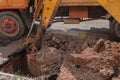 Excavator working on the Repair of pipe water on road Royalty Free Stock Photo