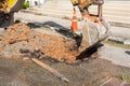 Excavator working on the Repair of pipe water and sewerage on road Royalty Free Stock Photo