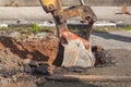 Excavator working on the Repair of pipe water and sewerage on road Royalty Free Stock Photo