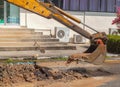 Excavator working on the Repair of pipe water and sewerage on road Royalty Free Stock Photo