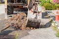 Excavator working on the Repair of pipe water and sewerage on road Royalty Free Stock Photo