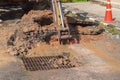 Excavator working on the Repair of pipe water and sewerage on road Royalty Free Stock Photo