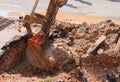 Excavator working on the Repair of pipe water and sewerage on road Royalty Free Stock Photo