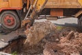 Excavator working on the Repair of pipe water and sewerage on road Royalty Free Stock Photo