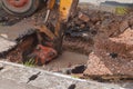 Excavator working on the Repair of pipe water and sewerage on road Royalty Free Stock Photo