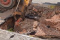 Excavator working on the Repair of pipe water and sewerage on road Royalty Free Stock Photo