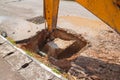 Excavator working on the Repair of pipe water and sewerage on road