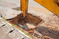 Excavator working on the Repair of pipe water and sewerage on road Royalty Free Stock Photo